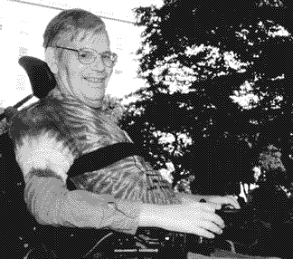 photo of Evan Kemp at an Adapt action wearing a tie-dyed shirt and a big smile.