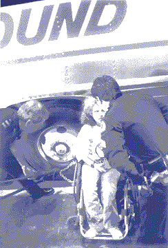 photo shows a woman who has chained her chair to the big hubcap of a Greyhound bus. One policeman bends over to scold her while another uses a bolt-cutter to sever the chain.