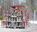 photo of the governor mounted on an enormous road-working machine